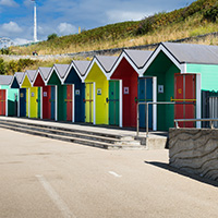 Logo of Elah Exodus Luxury Apartments and Homes featuring stylized mountain shapes in gold and blue with the name prominently displayed and a focus on luxury living options. 2 bedroom and stylish designs.