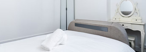 Logo of Elah Exodus Luxury Apartments and Homes featuring stylized mountains in gold and navy background representing quality living and three premium lifestyle options.