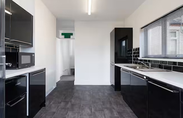 young woman relaxing on a sofa eating a bowl of salad wearing headphones colorful outfit enjoying a cozy moment 3 healthy eating trends