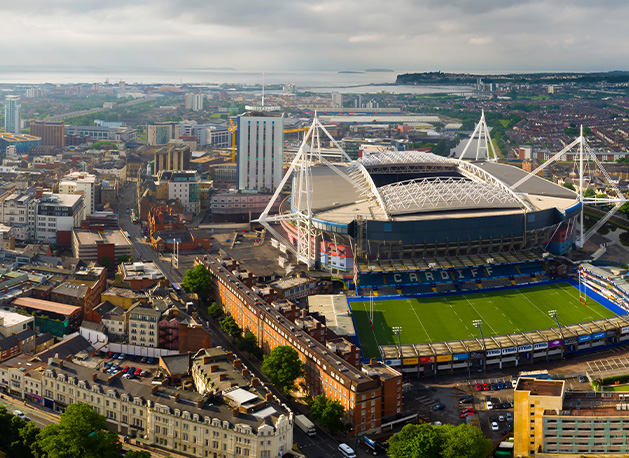 colorful beach huts aligned in a row with five distinct colors and charming architectural design against a sunny sky
